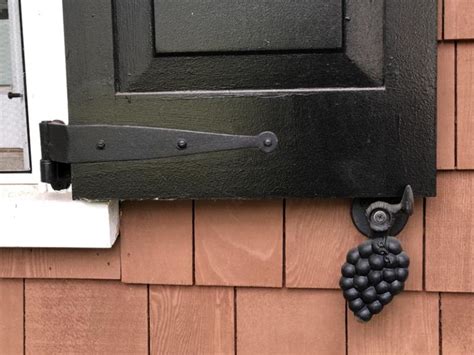 house with shutter with metal dog|exterior shutter dogs.